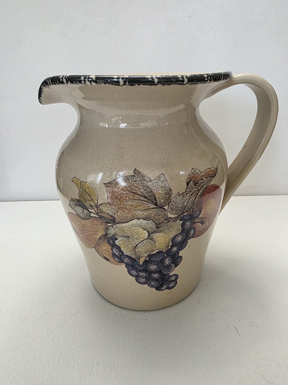 Vintage Beige Ceramic Pitcher with Fruit Motif and Black-Rim Accent
